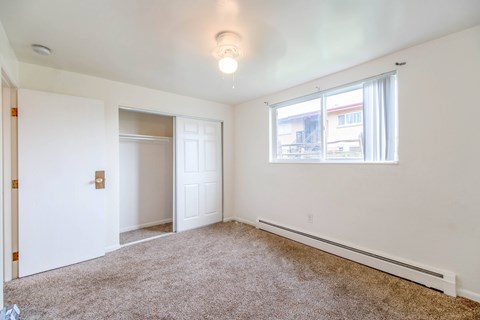 A room with white walls and a carpeted floor.