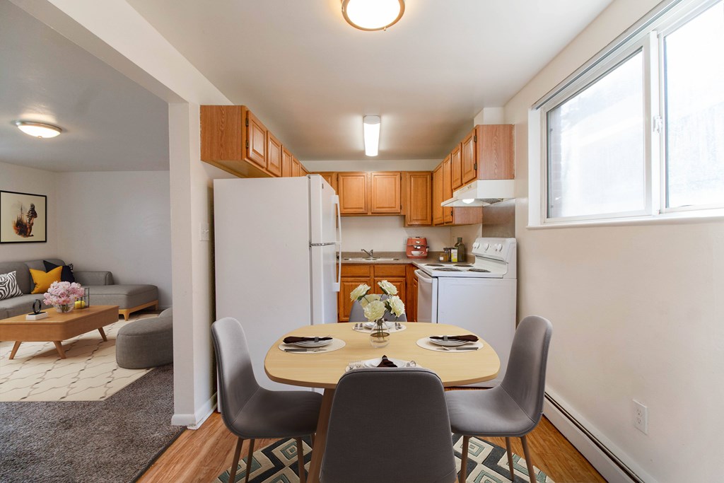 A dining room with a table set for two.