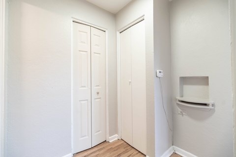A white door is in a room with a white wall.