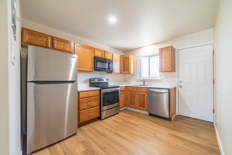 A kitchen with wooden cabinets and stainless steel appliances.