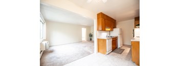 A kitchen with wooden cabinets and white appliances.