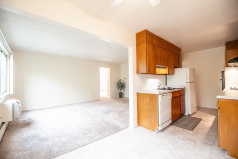 A kitchen with wooden cabinets and white appliances.