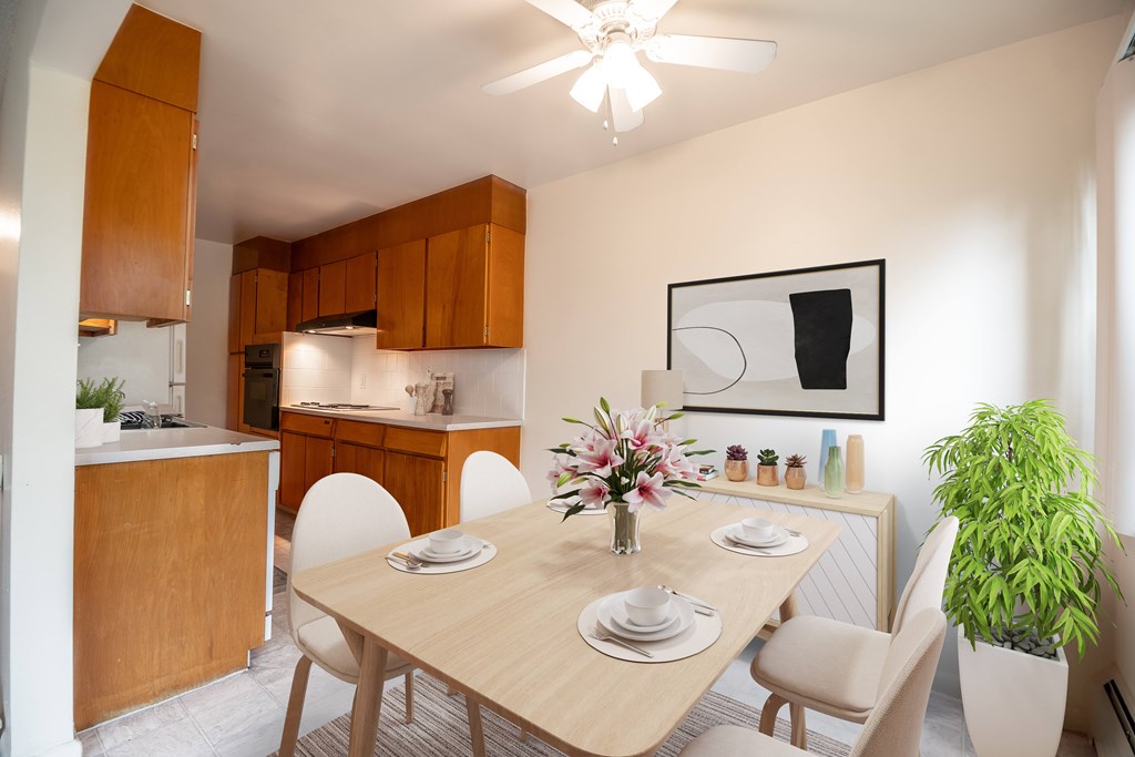 A dining room with a wooden table and chairs.