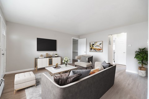 A modern living room with a grey sofa and a white armchair.