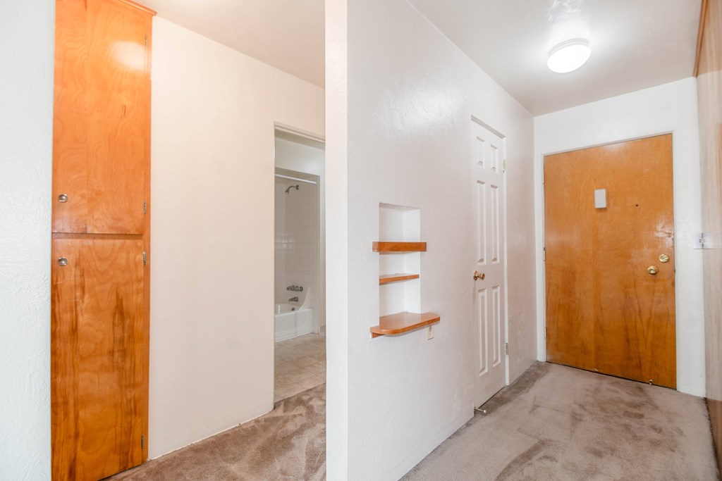 A room with a brown door and a white door.