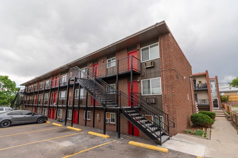 A red and black building with a staircase outside.