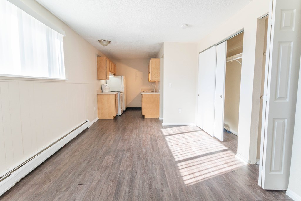 A room with wooden floors and white walls.