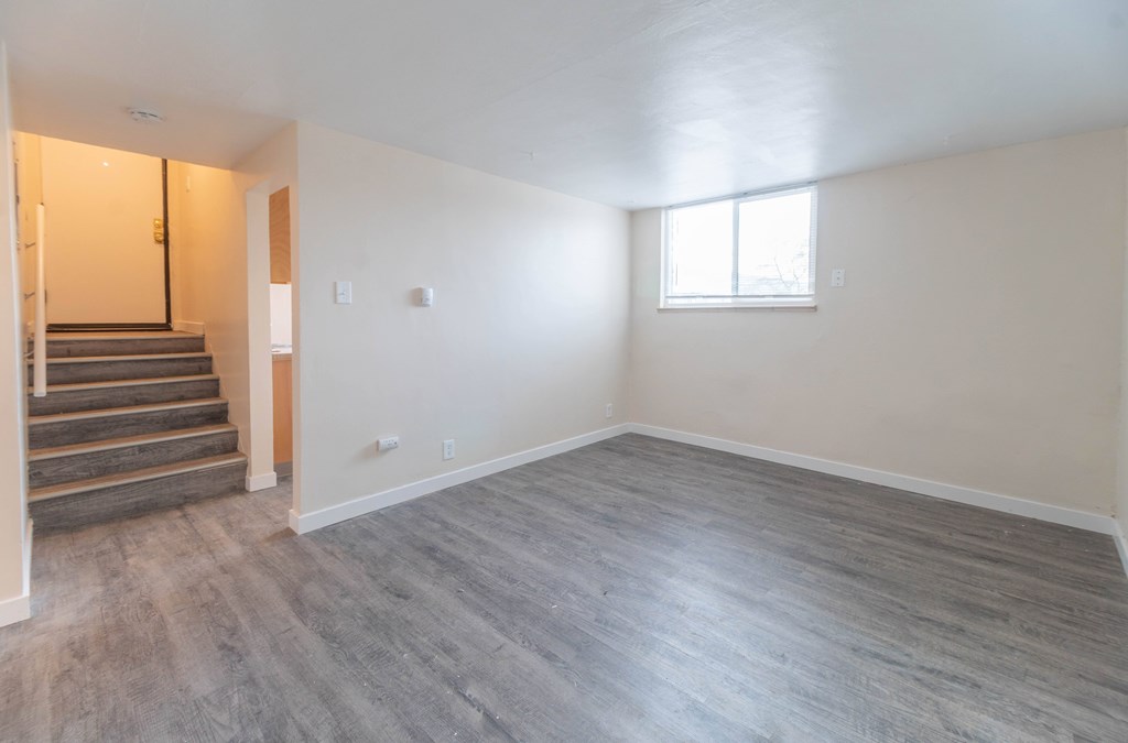 A room with a window and a staircase.