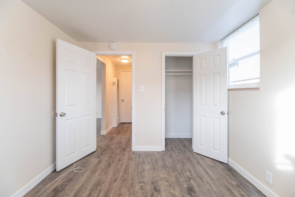 A room with white walls and a wooden floor.