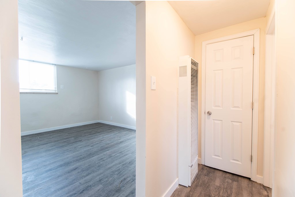 A room with a white door and a window.