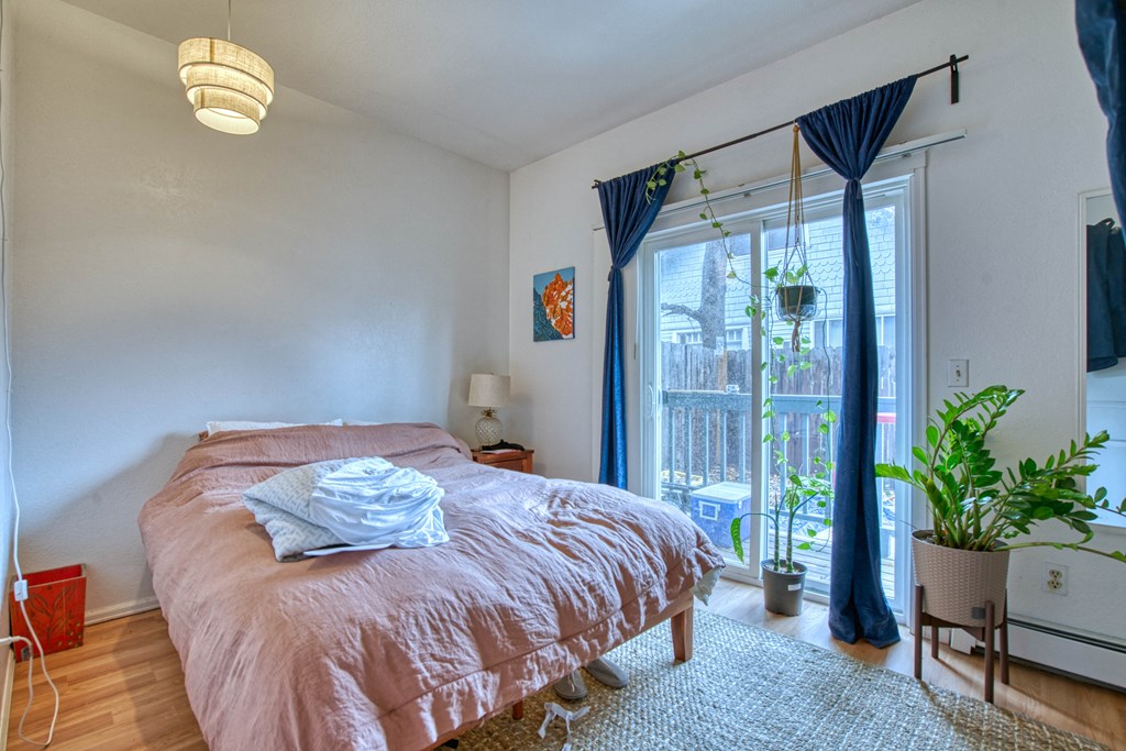 a bedroom with a bed and a large window