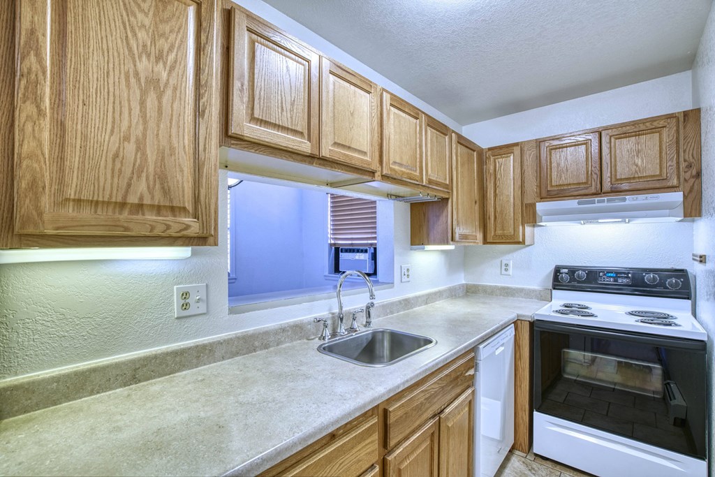 a kitchen with wooden cabinets and white appliances
