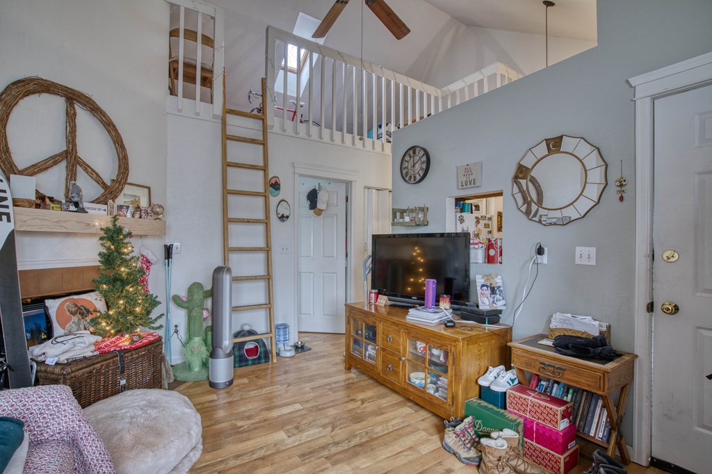 a living room filled with furniture and a christmas tree
