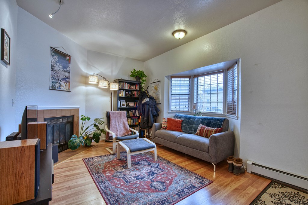 a living room with a couch chair and fireplace