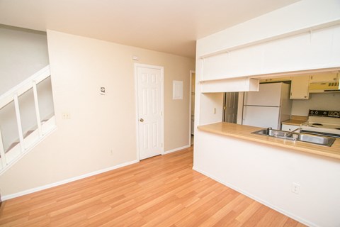 A kitchen area with a sink and stove top oven.