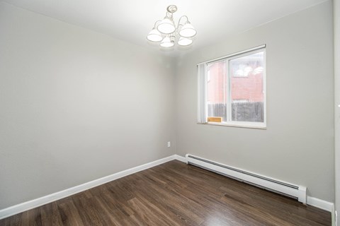 A room with a window and a radiator on the wall.