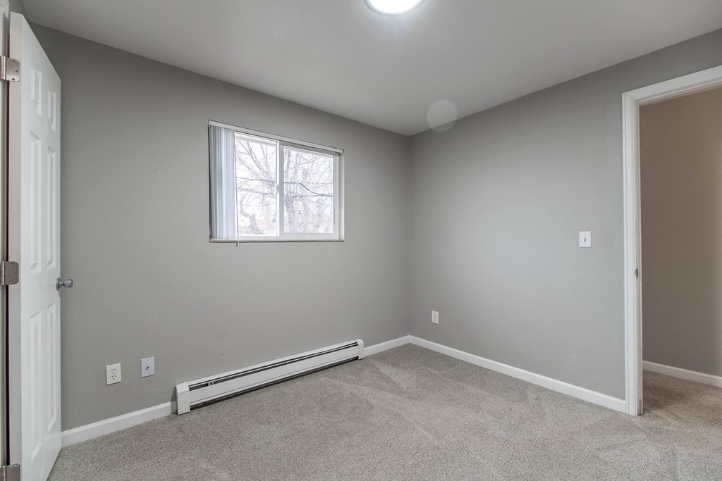 A room with a window and a door.