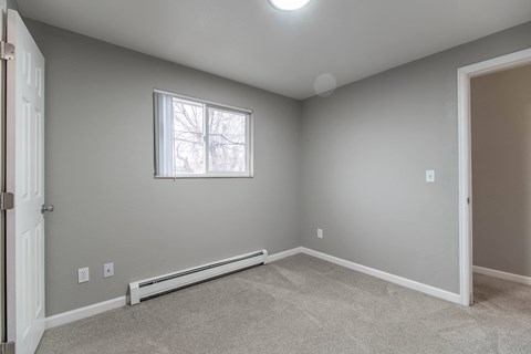 A room with a window and a door.