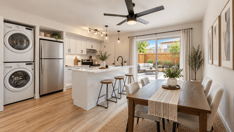 A modern kitchen with a dining table set for six.