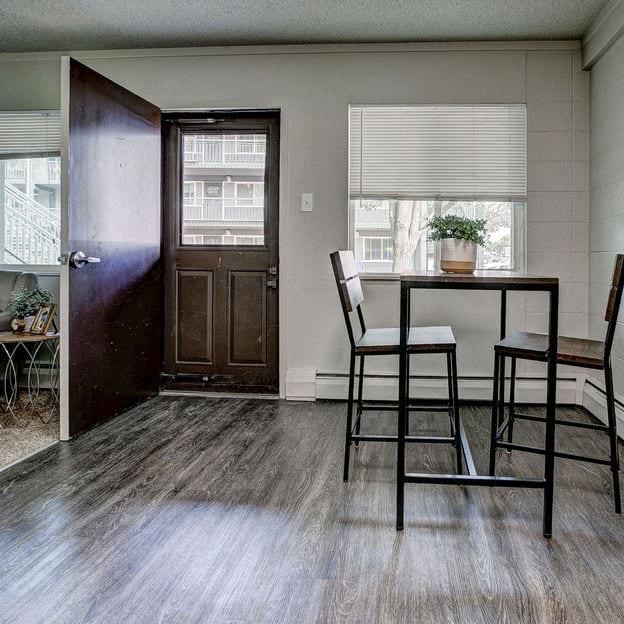 a living room with a table and chairs and a door