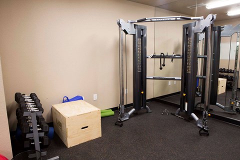 a gym with weights and a box in the corner