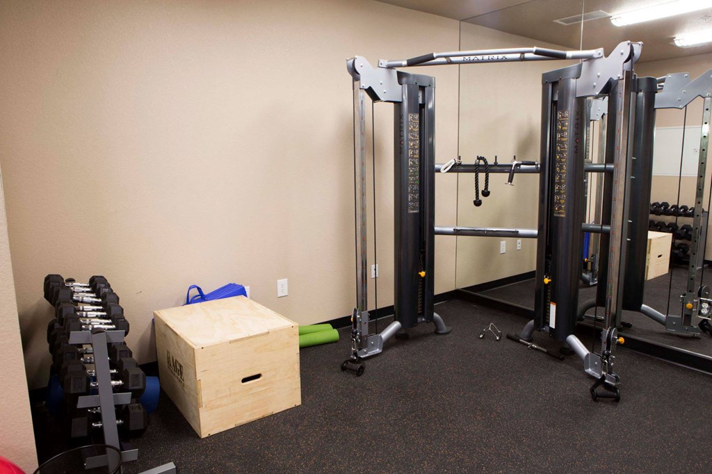 a gym with weights and a box in the corner