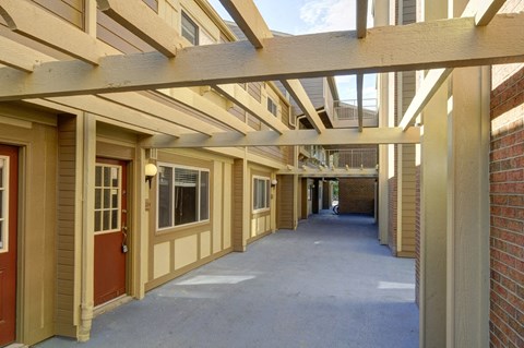 the outlook of an empty corridor of a building with a porch