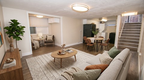 A living room with a couch, chairs, and a coffee table.