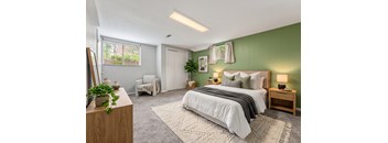 A bedroom with a large bed and a green wall.