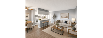 A modern living room with a kitchen in the background.
