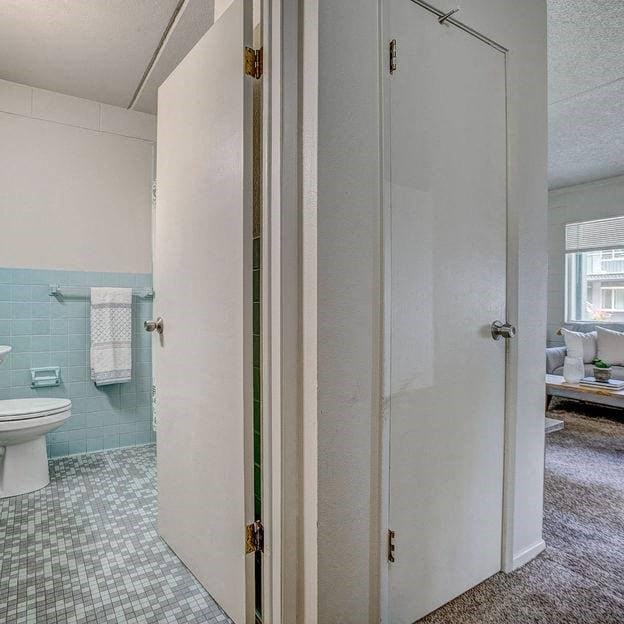a bathroom with a toilet and a shower