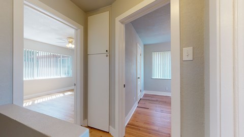 A white door is open to a hallway.