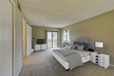 a master bedroom with a large bed and a large window