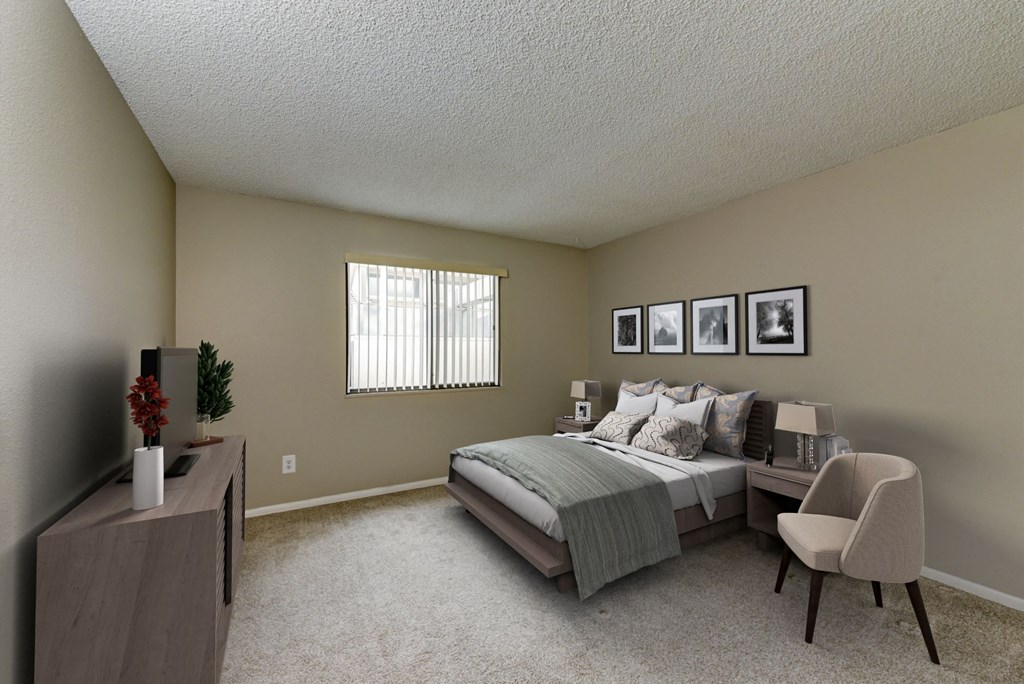 our spacious master bedroom has a king sized bed and a desk and chair