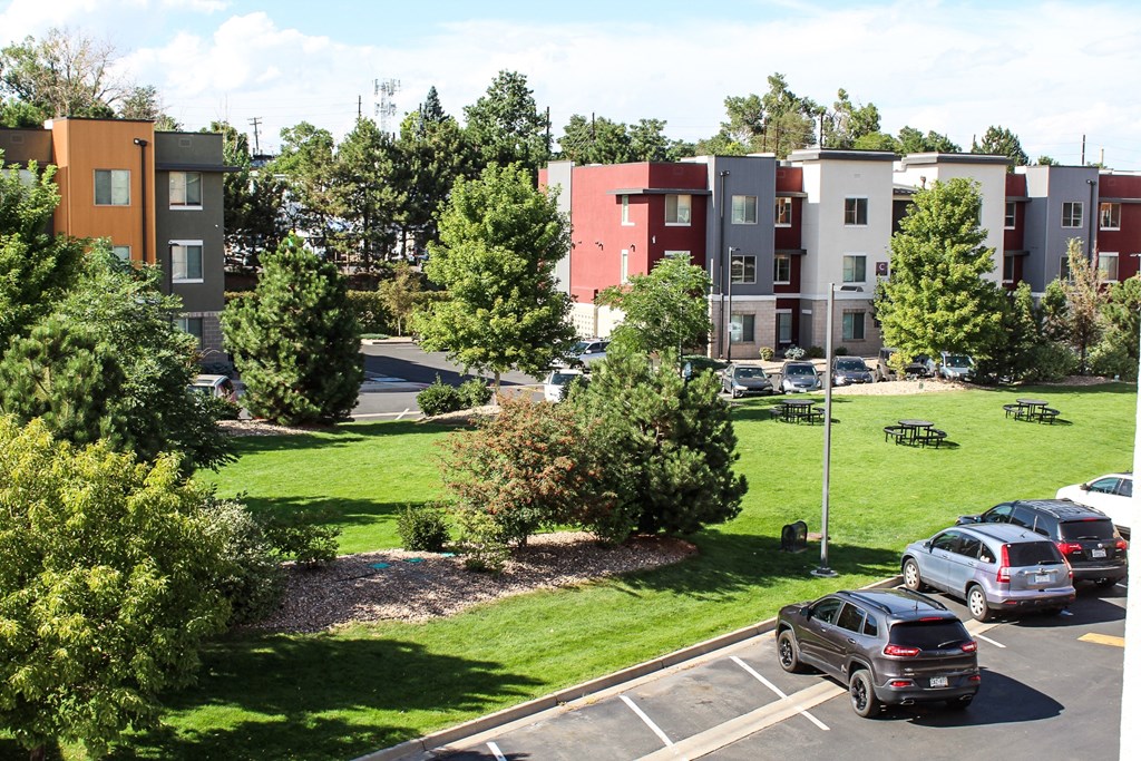 an aerial view of an apartment complex with cars parked in a parking lot