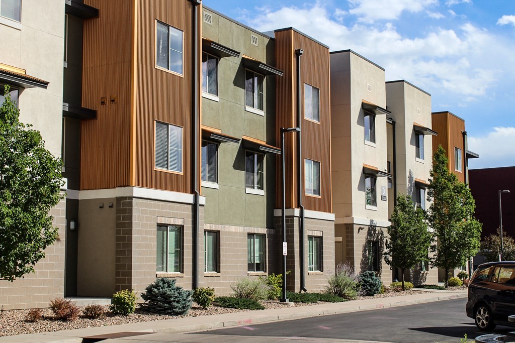 a row of apartment buildings on a city street