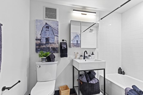 A white toilet sits next to a sink in a small bathroom.