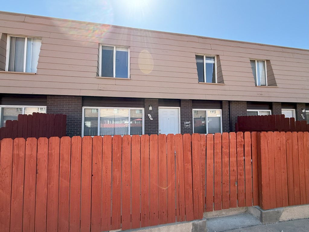 A building with a red fence in front of it.