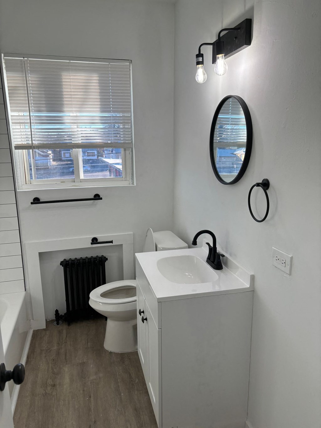 a bathroom with a sink and a toilet and a window
