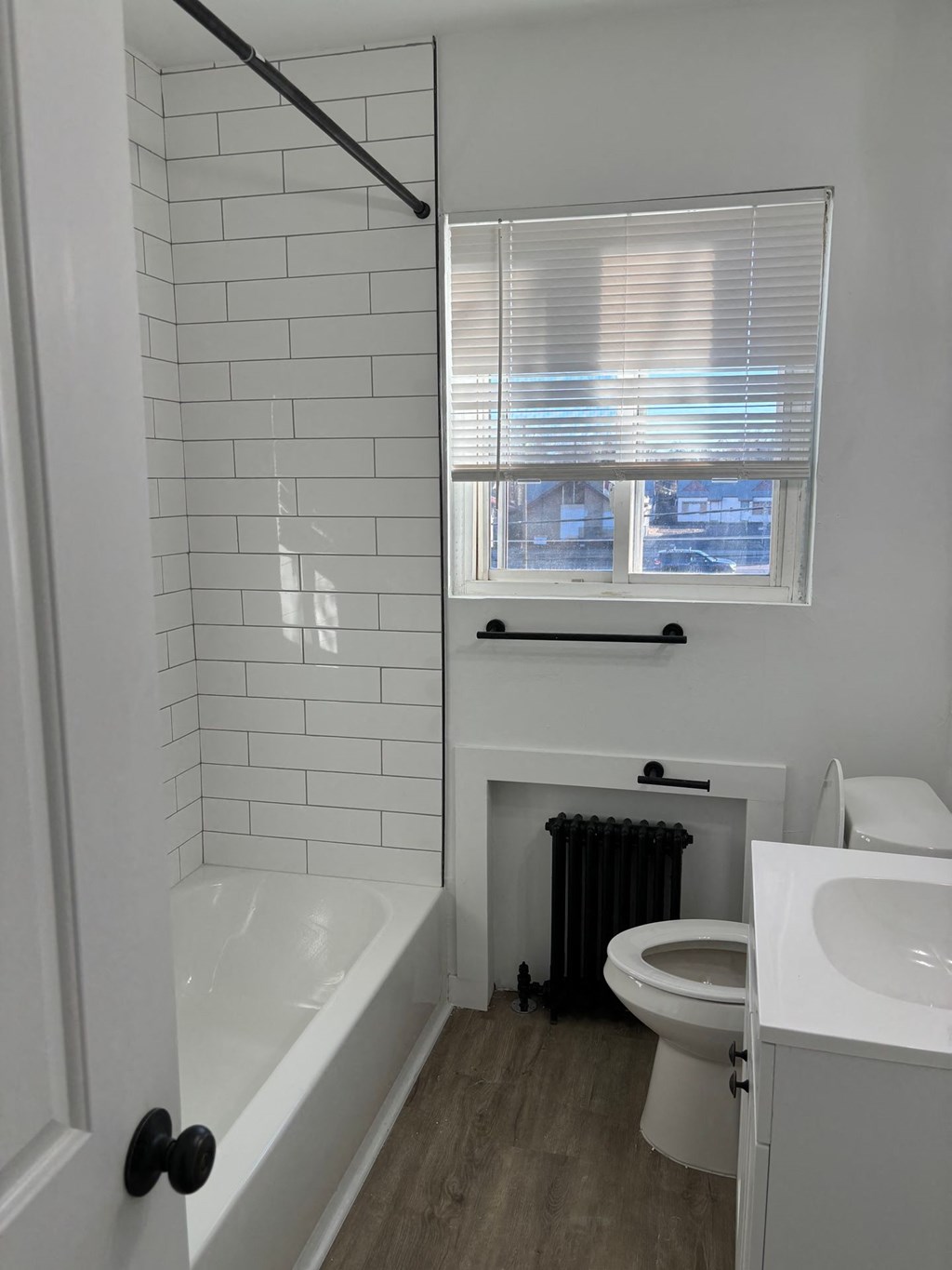 a bathroom with a toilet and a tub and a sink