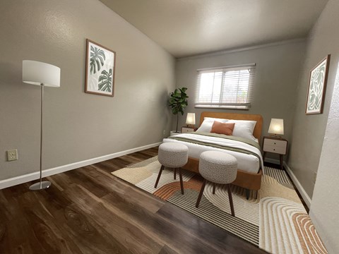 A bedroom with a bed, two lamps, and a plant.