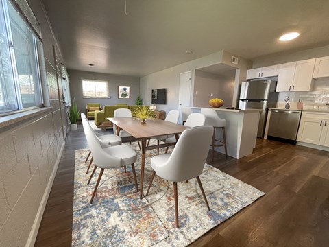 A dining room with a table and chairs.
