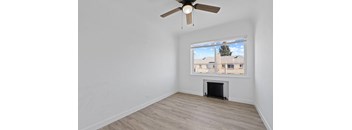 a living room with a ceiling fan and a window