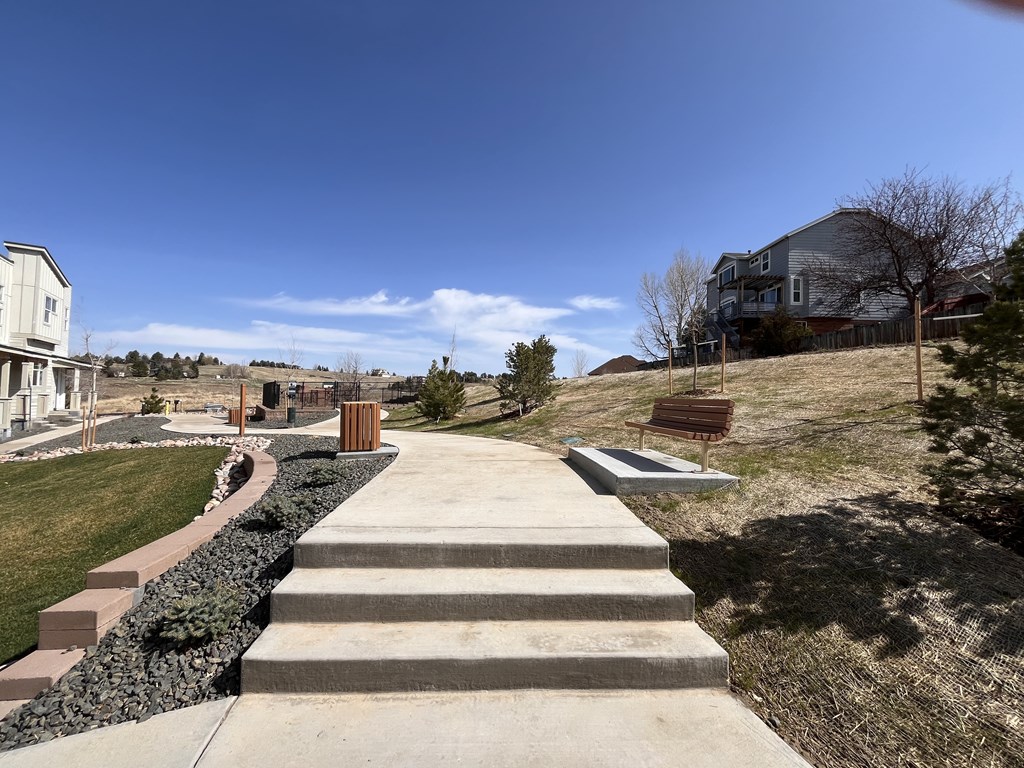 Walking paths with benches at The Townhomes at Pine Drive, Parker