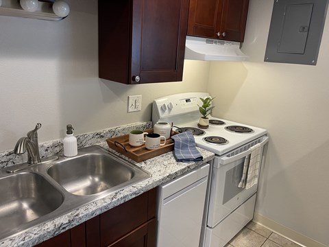 A kitchen with a white oven and a marble countertop.
