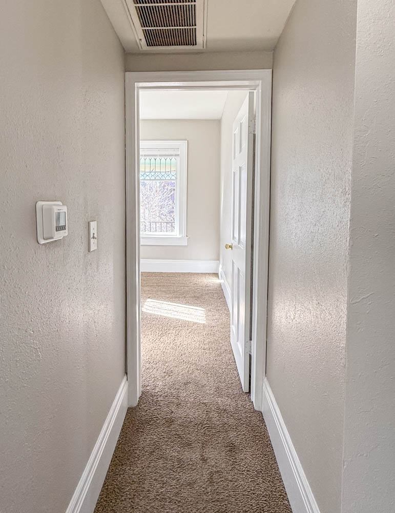 A hallway with a door at the end.