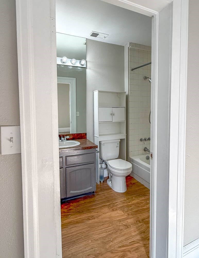 A bathroom with a toilet, sink, and shower.