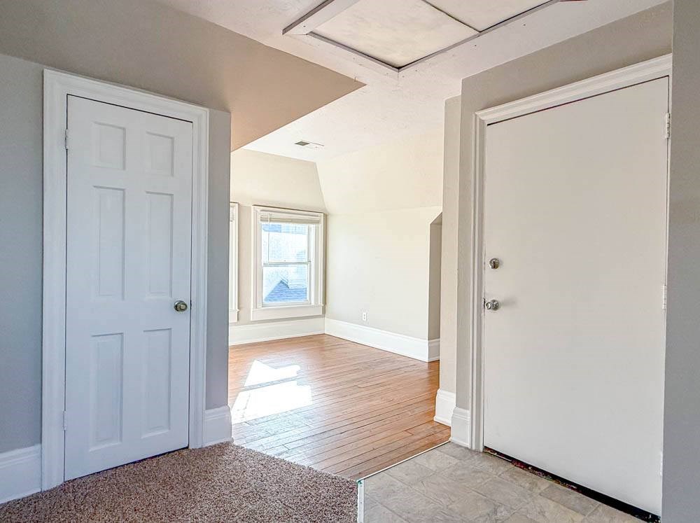 A room with a white door and a window.