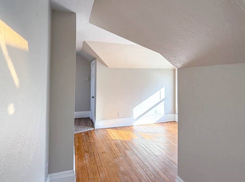 A room with wooden floors and white walls.