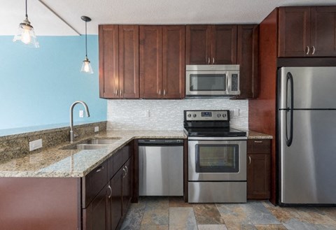 A kitchen with a stove, oven, and refrigerator.